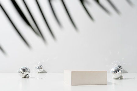 A minimalistic scene of a podium with christmas decorative balls and pine tree on light background. Catwalk for the presentation of products and cosmetics. Showcase with a stage for products, mockup design, seasonalの写真素材