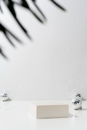 A minimalistic scene of a podium with christmas decorative balls and pine tree on light background. Catwalk for the presentation of products and cosmetics. Showcase with a stage for products, mockup design, seasonalの写真素材
