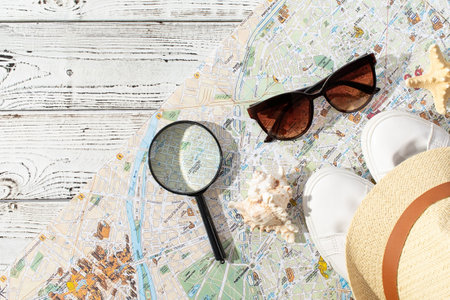 traveler accessories with map, devices and clothes on white background. Top view travel or vacation conceptの写真素材