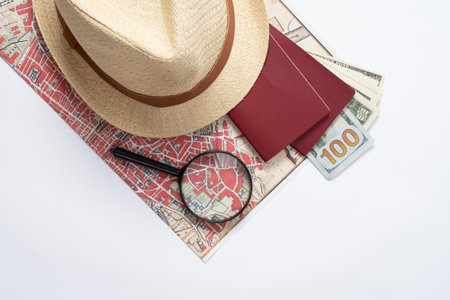 traveler accessories with map, devices and clothes on white background. Top view travel or vacation conceptの写真素材
