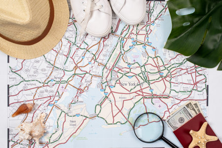 traveler accessories with map, devices and clothes on white background. Top view travel or vacation conceptの写真素材