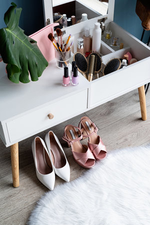 closeup of elegant high heel shoes standing under feminine dressing table