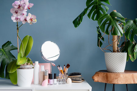 Stylish room interior with elegant dressing table and plants