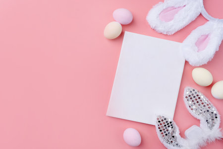 Spring holidays, Happy Easter. Pastel colored Easter eggs with blank white frame for mockup design on pink backgroundの写真素材