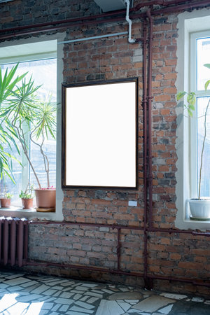 Blank picture frames on brick wall with glowing lamp in the gallery , mock upの写真素材