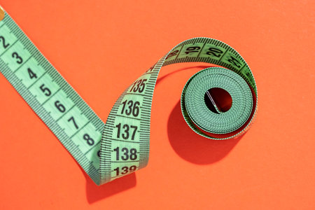 Dieting concept. colorful measuring tapes top view on bright red background, flat lay, pattern