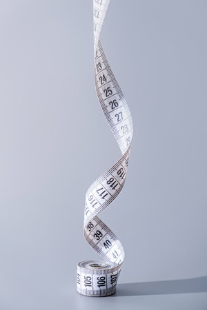 Dieting concept. colorful measuring tapes top view on gray background