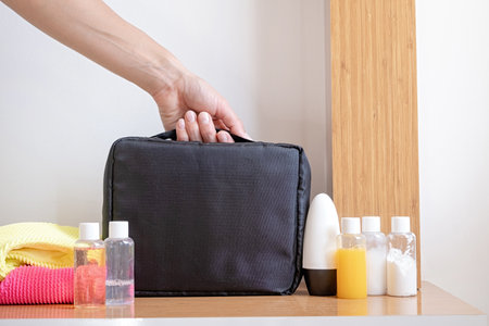 Travel cosmetics kit with bottles, pills and cosmetics on bed, top viewの写真素材