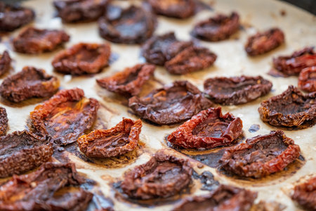 Pile of sundried or dried tomato halves on baking trayの写真素材