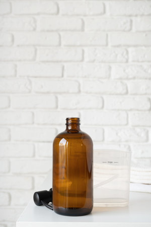 Recycled plastic pump bottle for mock-up. Minimalism brand packaging mockup design on white brick wall backgroundの写真素材