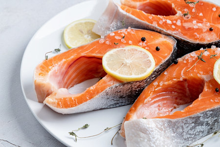 Stake Fish trout with lemon and spices on cement backgroundの写真素材
