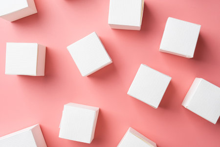 blank white block cubes on wooden table over light pink wall, Business communication conceptの写真素材