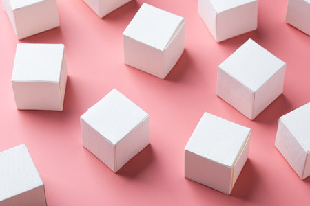 blank white block cubes on wooden table over light pink wall, Business communication conceptの写真素材