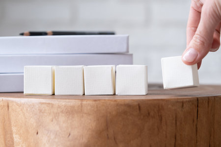 five blank white block cubes for writing a word on wooden table, Business communication conceptの写真素材