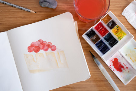 unrecognizable woman drawing watercolor on hotel room table
