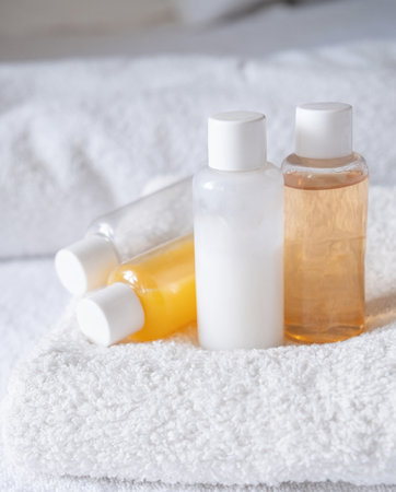 Travel cosmetics kit with bottles, pills and cosmetics on bed, top viewの写真素材