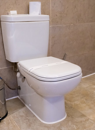 Ceramic toilet bowl with paper line hygiene textの写真素材