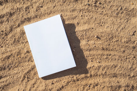 book mockup design. reading on vacation. blank book mockup on sandy beach