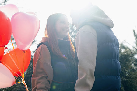 Outdoor photo of happy young woman enjoying date. cheerful romantic couple dating outdoors with...