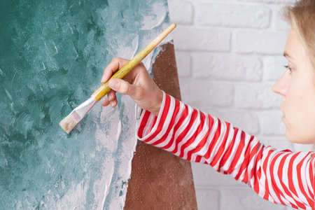 Talented Female Artist working on her painting on Large Canvas. Contemporary Painter Creating Abstract Modern Artの写真素材