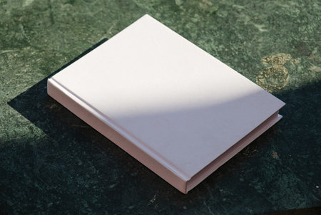 book cover mockup design. blank book mockup on green marble stone coffee table, shadow overlayの写真素材