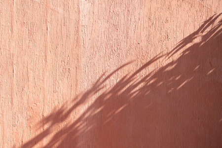terracotta background textured wall with shadow overlayの写真素材