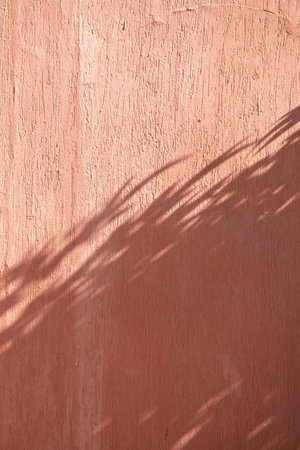 terracotta background textured wall with shadow overlayの写真素材