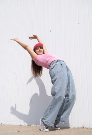 plus size woman wearing casual clothes dancing on white wall background in the street , leisure and funの写真素材
