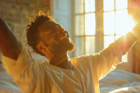 Handsome Young Man Waking up in the Morning, Stretches and Gets Out of Bed, Sun Shines From the Apartment Window in Bedroom, He is Ready for Business Opportunities, Achievements, Adventures. ai generatedの素材