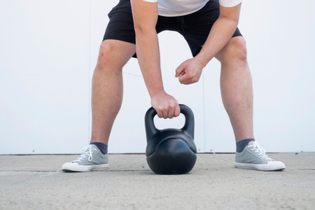 Sportive man workout with kettlebell. Strength and motivation.の写真素材