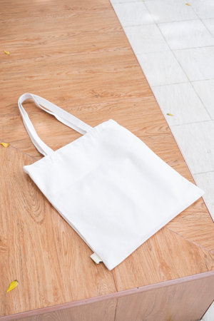 Canvas tote bag on the bench in the park mockup. Rustic linen shopper bag mock up for branding...