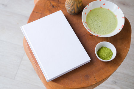 blank book mockup on wooden coffee table with green matcha tea, Asian style
