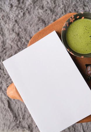 blank magazine mockup on wooden coffee table with green matcha tea and glasses, Asian styleの写真素材