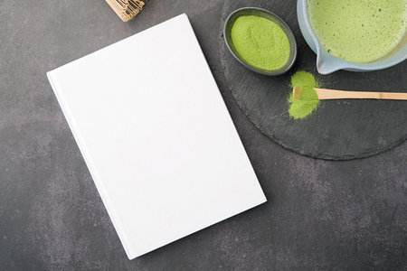 blank book template on on dark table with green matcha tea, Asian style