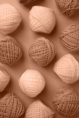 Mocha Mousse - color of the year 2025. yarn wool on brown backdrop, top view flat lay. Knitting patternの写真素材