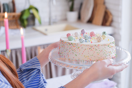 Happy Easter. woman serving table for Easter dinner and holding Easter cake