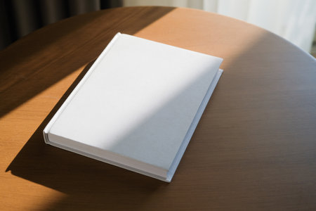 book cover mockup design. blank book template on wooden coffee table in living room or hotel room,...
