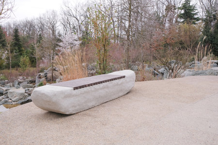 modern stone and wood bench in a Japanese style garden or park
