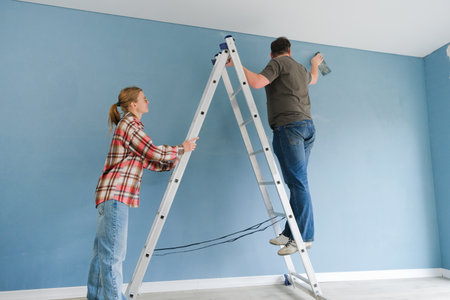 Happy couple renovating new house apartment, discussing renovation. Home makeover, renovation concept. Family man woman repair flat themselves.の写真素材