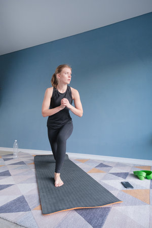 young athletic woman doing exercises at home