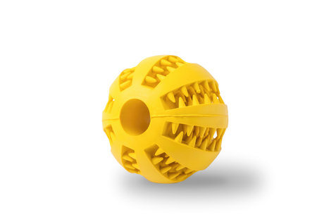 Dog pet toy yellow ball for snacks isolated on white background with shadowの写真素材