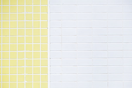 Tile wall with white and yellow tiles, outdoor wall