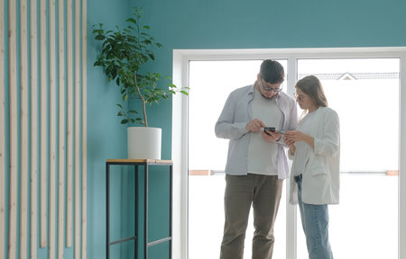 Teamwork meeting, tablet and business people in office workplace. millennial man and woman working in small officeの写真素材