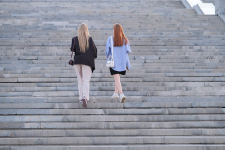 two female friends walking up the stairs