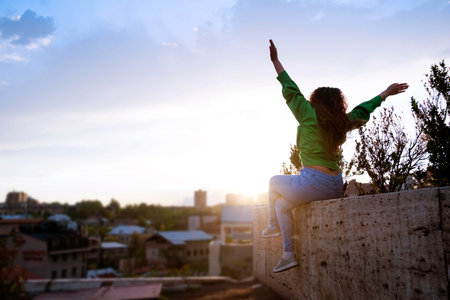 Young female tourist enjoys the view of Yerevan city at sunset. back view. Lifestyle, travel, tourism, active life.の写真素材