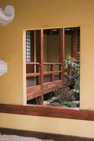 closeup of traditional Japanese garden in the inner yard of the house, view through the inner window