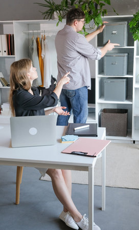 Teamwork meeting, tablet and business people in office workplace. millennial man and woman working in small office discussing documentsの写真素材