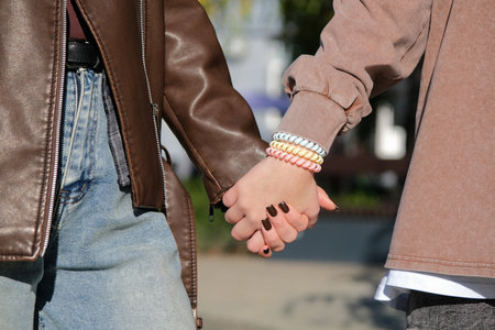 mother and teen girl holding hands in the street, closeupの写真素材