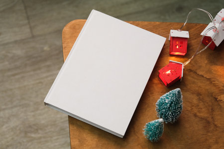 Blank book mockups with Christmas and New Year decorations, festive book mock up. Festive lights...