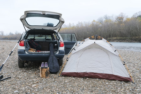 tent and guitar on the river side near the car, the place to camping can drive our vehicle toの写真素材